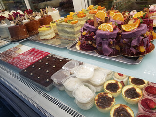 Assorted differentcakes with cream, chocolate and berries