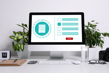 Computer with app for online voting on white table