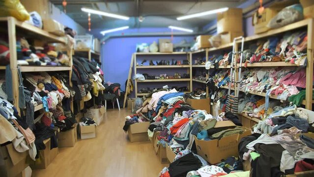 warehouse. humanitarian aid. second hand. Shelves with donated things and clothes for refugees and migrants, low-income and poor people. Community Volunteer Center