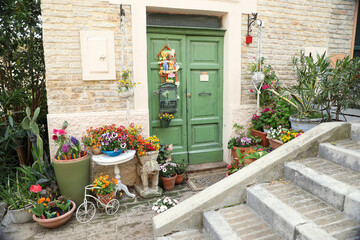 Fototapeta na wymiar Beautiful house with decor and flowers near entrance