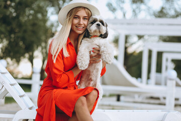 Pretty woman with her cute dog on vacation