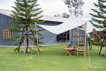 Canopies anchored to steel structures provide shade. White tarpaulin taut, shading from the sun and...