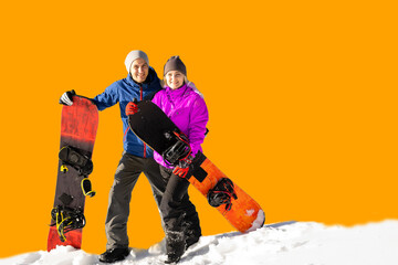 Happy couple of snowboarders having fun with snowboards