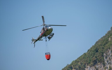 Fototapeta na wymiar Helicopter used to transport water to put out fires