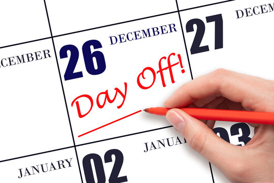 26th day of December. Hand writing text DAY OFF and drawing a line on calendar date 26 December. Vacation planning concept. Winter month, day of the year concept.