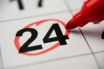 The calendar 24th day of the month is circled. A red marker circles the twenty-fourth day of the...