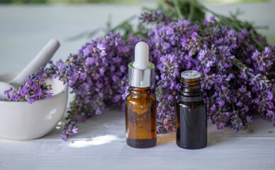 Fototapeta na wymiar Essential oil of lavender, on a wooden background.