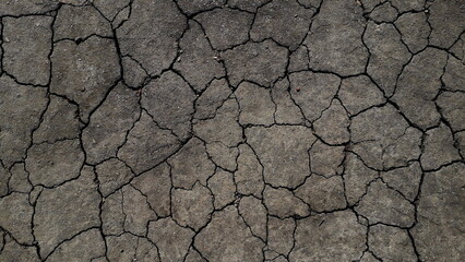 The earth crackled from drought, the soil without plants.
Texture of dry soil.