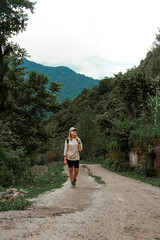 Obraz premium Travel. Girl travels through the mountains and waterfalls of wild nature. Unity, mental health, eco travel. Hiking in the mountains, van life vibes, travelling,good moments, digital detox