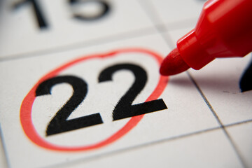 The calendar 22nd day of the month is circled. A red marker circles the twenty-second day of the...