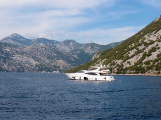 Beautiful view of the pleasure yacht in the bay with mountains in the background