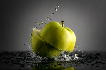 Fresh green apple with water splash