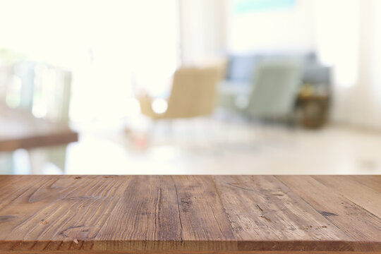 Wooden empty table in front of Living room interior. For product display and presentation