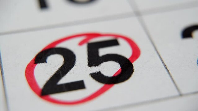 The calendar 25th day of the month is circled. A red marker circles the twenty-fifth day of the month from the paper calendar. A very important date in the calendar
