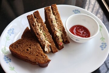 Healthy Chicken mayonnaise sandwich served with Tomato ketchup. homemade multigrain brown bread. Copy space.