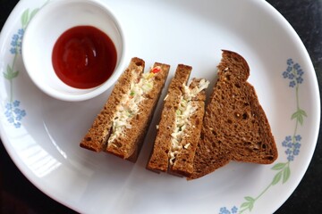 Healthy Chicken mayonnaise sandwich served with Tomato ketchup. homemade multigrain brown bread. Copy space.