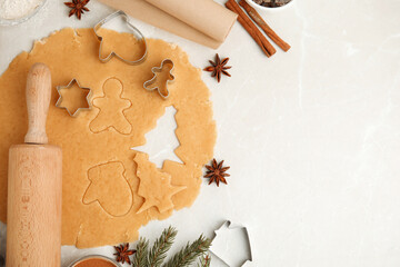 Flat lay composition with dough and cookie cutters on white table, space for text. Christmas biscuits - Powered by Adobe