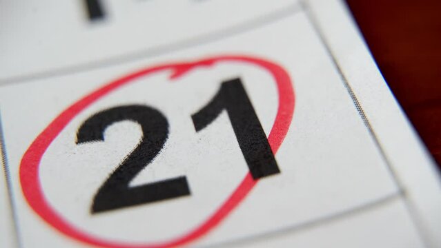 The calendar 21st of the month is circled. A red marker circles the twenty-first day of the month from the paper calendar. A very important date in the calendar