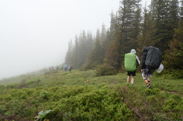 Tourist hike with large backpacks in the Carpathians.