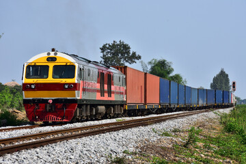 Naklejka premium Container-freight train by diesel locomotive on the railway in Thailand