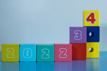 New Year Concept. Wooden blocks bearing numbers of 2022, 2023 and 2024 isolated on white...