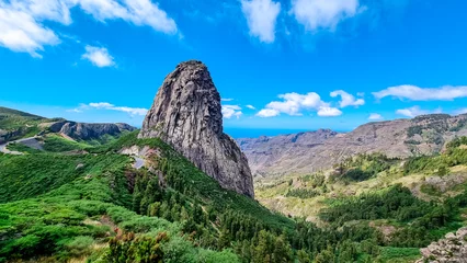 Foto op Canvas Scenic mountain road with view on massive volcanic rock formation Roque de Agando in Garajonay National Park on La Gomera, Canary Islands, Spain, Europe. Lava cone of old volcano. Sunny day in summer © Chris