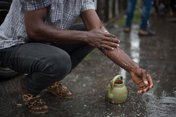Muslim man washes his hands before prayer ritual cleansing. Islamic religious rite - obrazy, fototapety, plakaty
