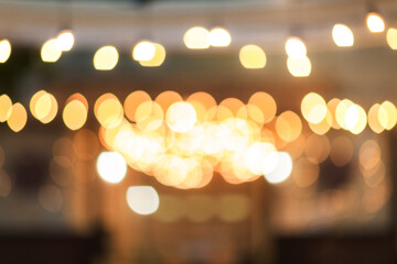 vintage tone blur image of food stall at night festival with bokeh	