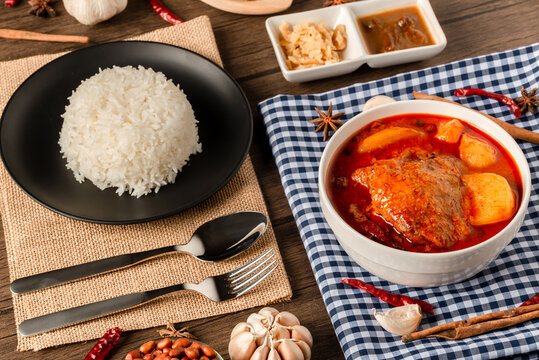 Chicken Massaman Curry on white bowl. Muslim curry or mussaman curry. Muslim style chicken and potato or chicken mussaman curry.