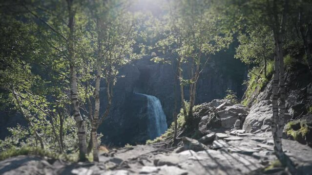A view of the waterfall falling into a deep canyon. Pan forward, slow-motion.