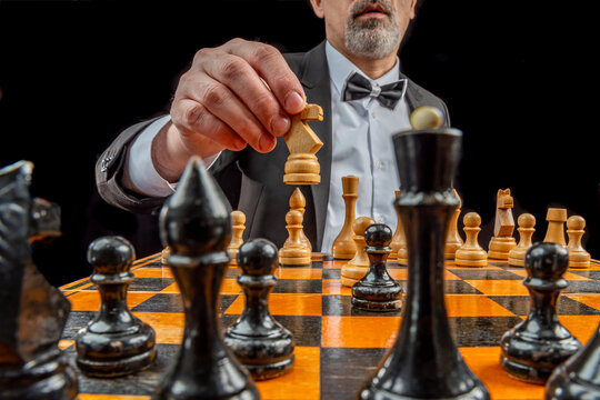 Businessman hands in black suite sitting and pointing chess king on vintage  table meaning of planning and strategy. Decision and achievement goal  concept. 11872620 Stock Photo at Vecteezy