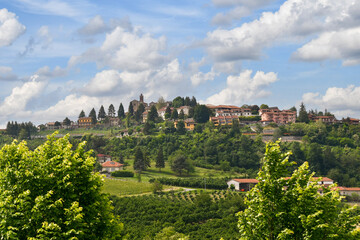 Fototapeta na wymiar View of the ancient village on the top of a hill in the Langhe area, popular tourist destination for wine and food lovers, Benevello, Cuneo, Piedmont, Italy