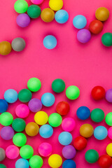 Abstract colored balls background. Multi-colored taw toy scattered on bright paper. Base for design nice backdrop, wallpaper, poster. Noisy surface texture
