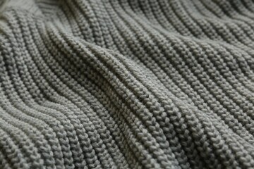Beautiful grey knitted fabric as background, closeup