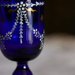 antique glass decanter in blue color in a luxurious interior. blue glass close-up