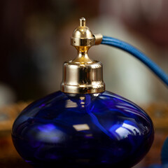 Vintage perfume bottle close-up in luxury interior. vintage round blue perfume bottle close-up