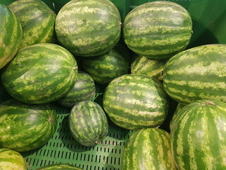Fresh watermelons displayed for sale in a supermarket