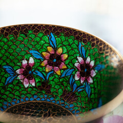 stained glass dish in a luxurious interior. crystal green plate with floral pattern. bohemian glass closeup