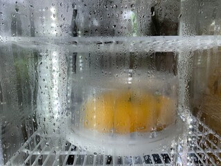 Frozen drops condensed steam water drops on the transparent window glass.