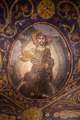An ancient fresco depicting a saint on the walls of the Church of the Holy Sepulcher. A beautiful and detailed icon made of small colored pebbles. The face of a saint