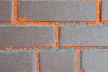 Brick wall. Brown with orange inserts.