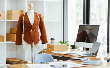 Clothing designer workspace, computer desktop , fabric color swatches at desk table.