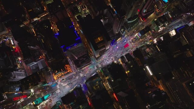Aerial birds eye overhead top down view of traffic passing through Times Square at night. Colourful lights in midtown. Manhattan, New York City, USA