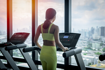 Fototapeta na wymiar sport fitness woman wearing sportwear with workout under exercise on treadmill machine gym is sport healthy body building in fitness lifestyle.