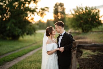 young couple the groom in a black suit and the bride in a white short dress