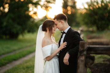 young couple the groom in a black suit and the bride in a white short dress