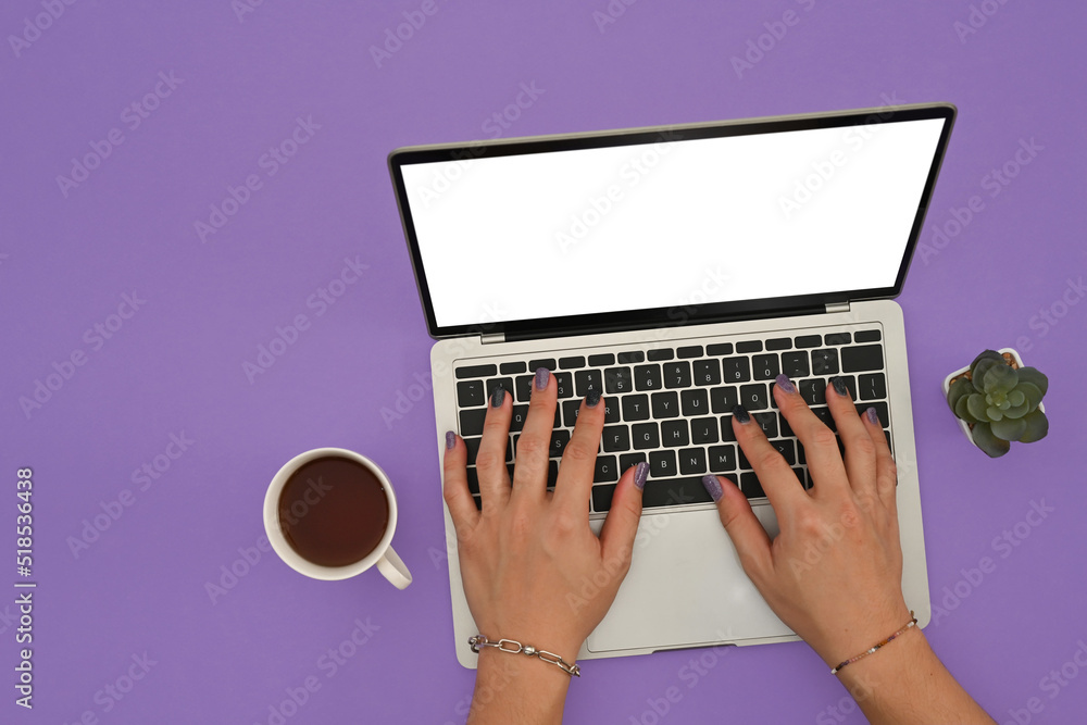 Poster top view of man's hands painted nails using empty white screen of laptop computer on the purple back