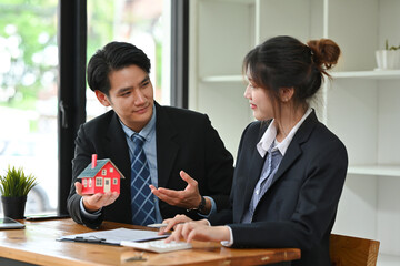 Happy Two Real Estate Agents in suits talking to each other, House for Sale, Mortgage for purchasing, Real estate agent, Mortgage or Rent House concept.