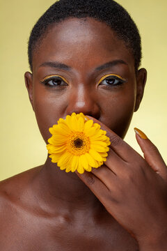 Portrait Of Woman With Yellow eyeshadow and gerbera