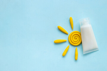 Sun protection lotion and plasticine sun. Summer skin care concept